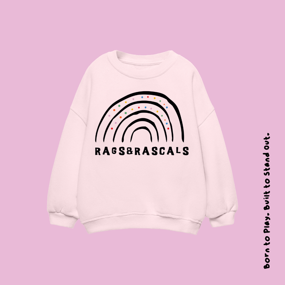 light pink sweatshirt with rainbow design and 'Rags & Rascals' branding.
