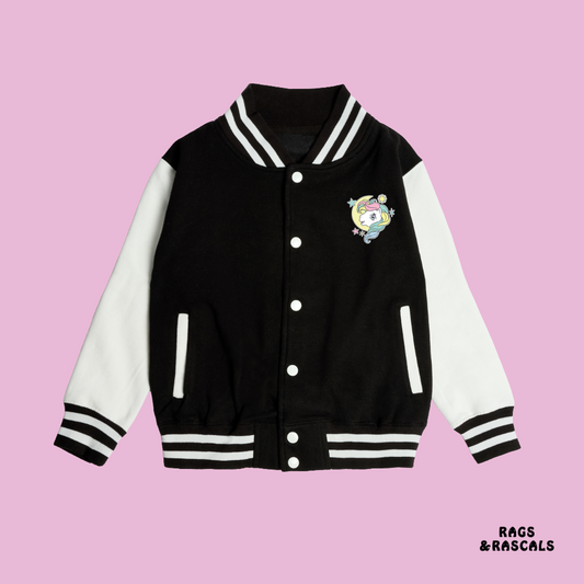 Black and white varsity jacket with a colorful pony head emblem, from a children's brand called 'Rags & Rascals'.