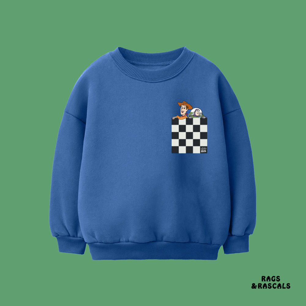 Blue Toy Story themed sweatshirt with a checkered pocket design, from a children's brand called 'Rags & Rascals'.