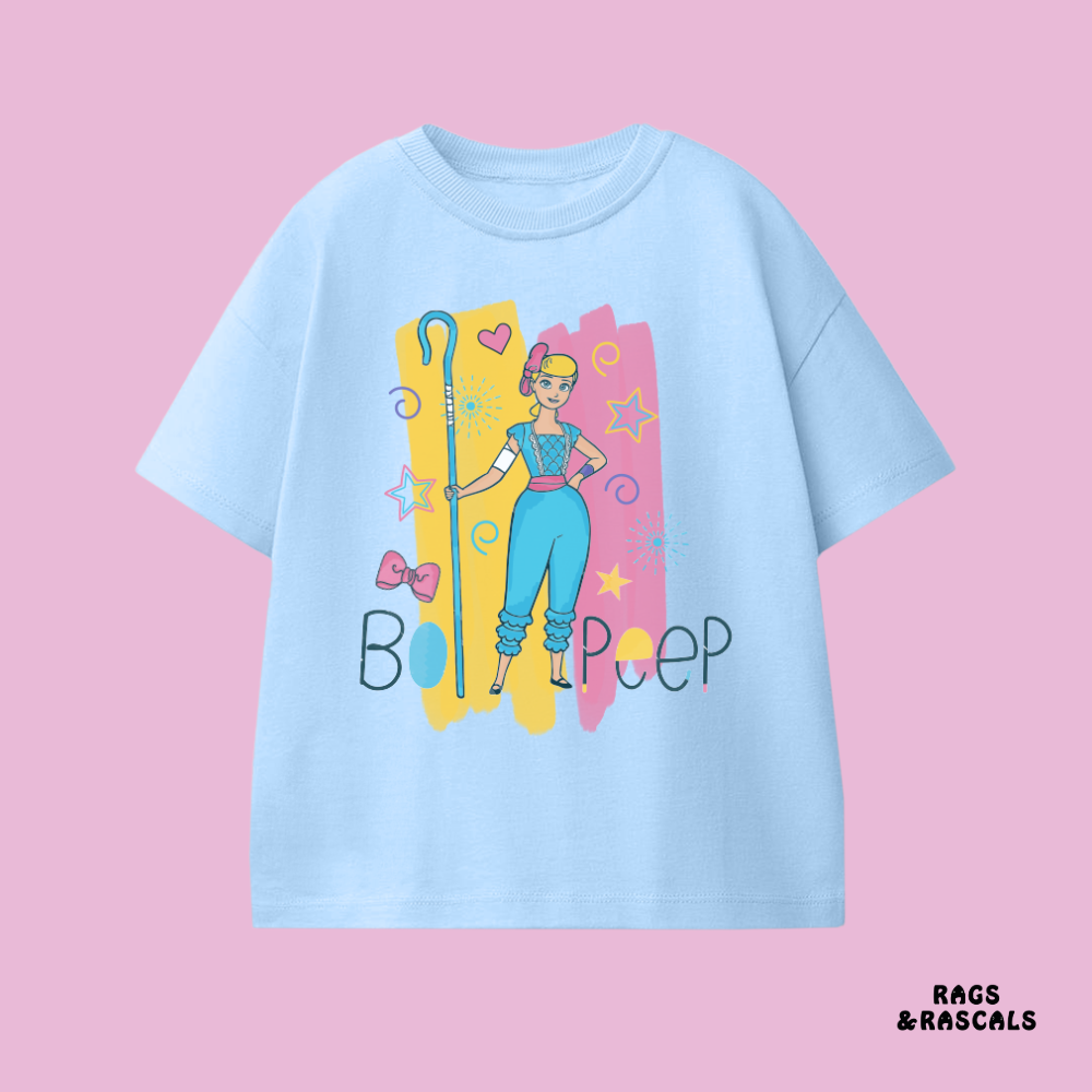 Light blue t-shirt with cartoon character and 'Boop' text, from a children's brand called 'Rags & Rascals' visible.