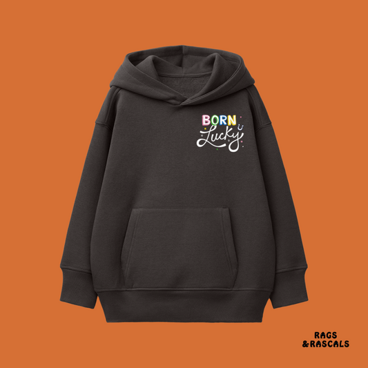 Black hoodie with 'Born Lucky' text on an orange background, featuring the brand 'Rags & Rascals'.