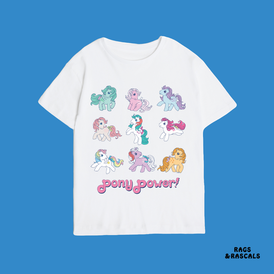 White t-shirt with colorful pony illustrations and 'pony power!' text on a blue background